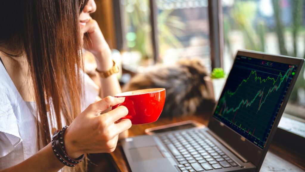 Woman taking a coffee whike looking at cryptocharts - 1280x720